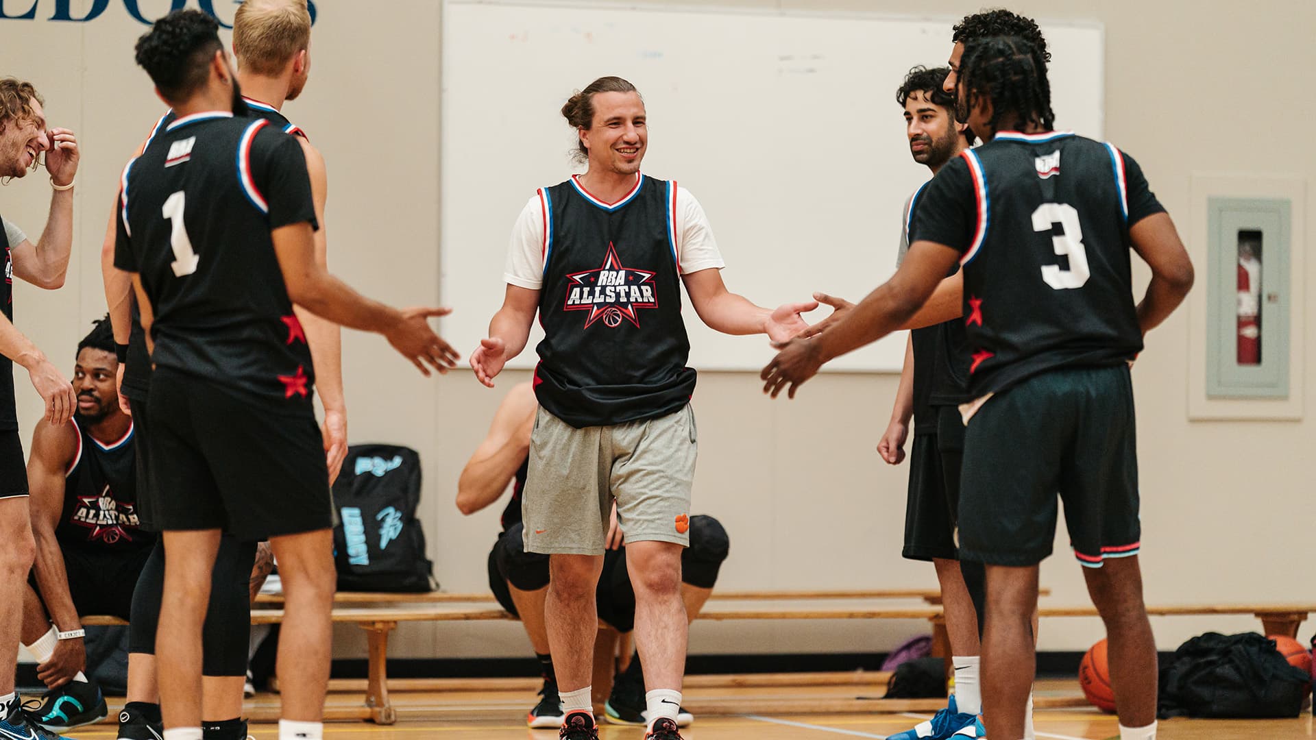 basketball players giving high fives at all star game